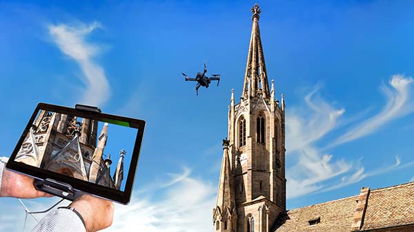 Drone in the air inspecting church roof